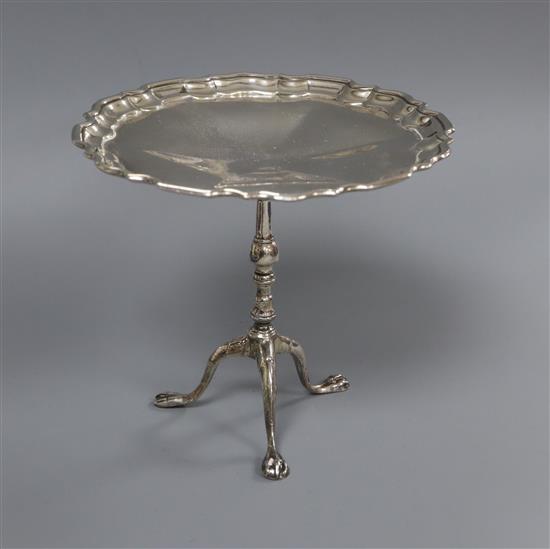 A George V silver miniature model of a pie crust rim occasional table, Goldsmiths & Silversmiths Co Ltd, London, 1915, height 10cm.